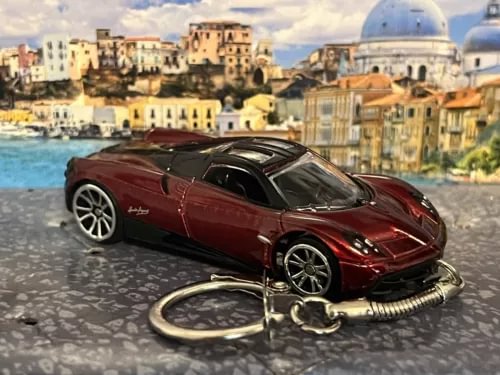 Diecast red toy car keychain with metal keyring and coiled leash