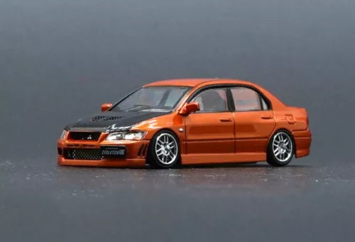 Orange and black diecast car model toy, front 3/4 view with sporty wheels