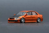 Orange and black diecast car model toy, front 3/4 view with sporty wheels