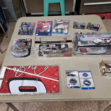 Assorted diecast NASCAR collectible cars in blister packs and accessories, on display