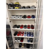 Diecast model car collection in a white display cabinet, assorted colors and styles