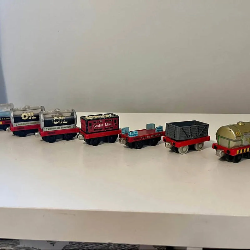 Diecast train car set with red, blue, black, and yellow cars