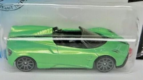 Green diecast roadster car with black stripe and detailed wheels, side view in blister pack