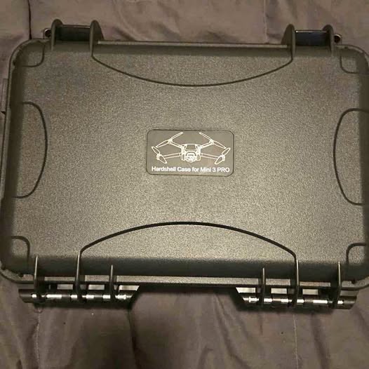 Hard-shell drone case with carry handle and centered drone logo label