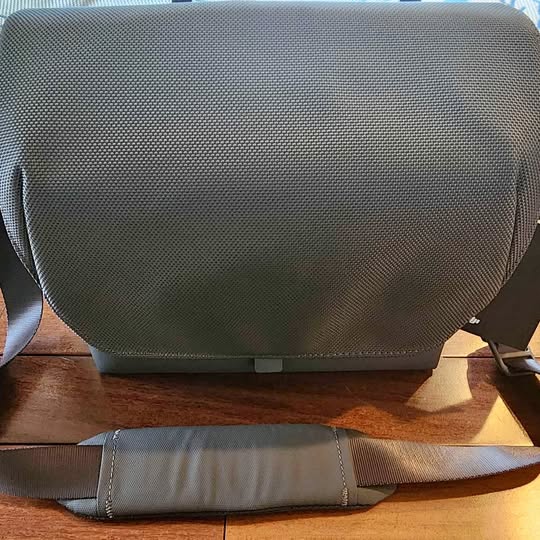 Gray drone carrying case shoulder bag with textured fabric and front flap