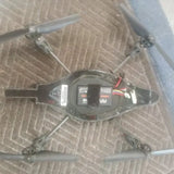 Large drone with four propellers and exposed electronics module on body