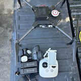 Quadcopter drone with white remote controller, top view and landing gear