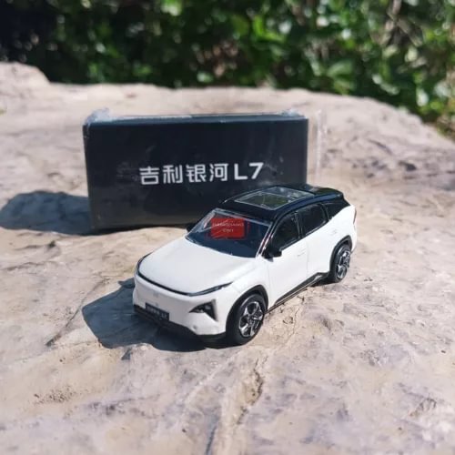 White diecast model car, front three-quarter view with black roof