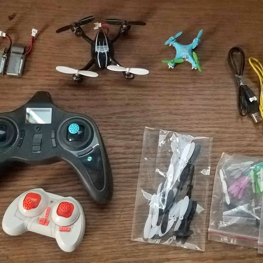Hubsan mini drone kit with remote controller and spare propellers in bags