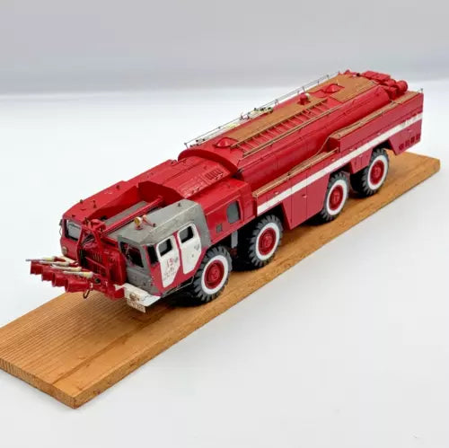 Red diecast fire truck model with extended ladder and front bumper details