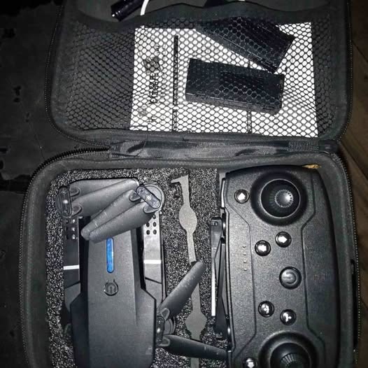 Compact quadcopter drone with camera and propellers in hard carrying case