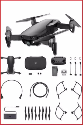 Black quadcopter drone with remote controller and accessory parts, unassembled kit