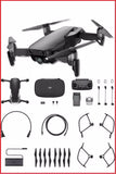 Black quadcopter drone with remote controller and accessory parts, unassembled kit