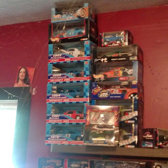 Diecast car collection in blister packs, multiple cars stacked on display