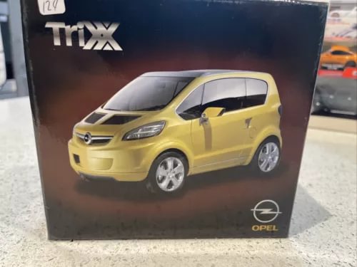 Bright yellow open-top Opel diecast model car with silver wheels