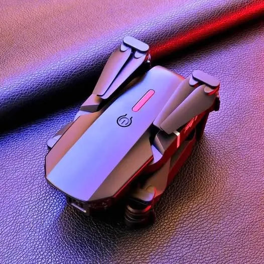 Compact silver drone with black propellers and red accents on the body