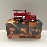 Red diecast fire engine truck model on display box, front side view