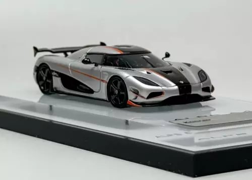 1:64 silver and black sports racing diecast car model on display base