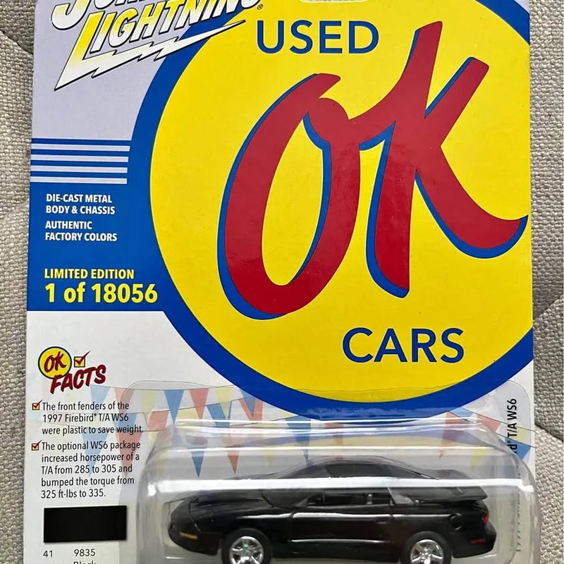 Black die-cast muscle car model in clear blister on yellow blue card