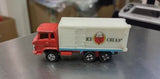 Diecast toy delivery truck with red cab and white ice cream box trailer