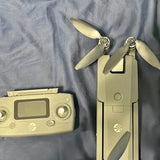 Beige camera drone with folded propellers and front control housing