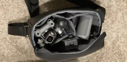 Grey drone combo case with mounted drone components and controller modules