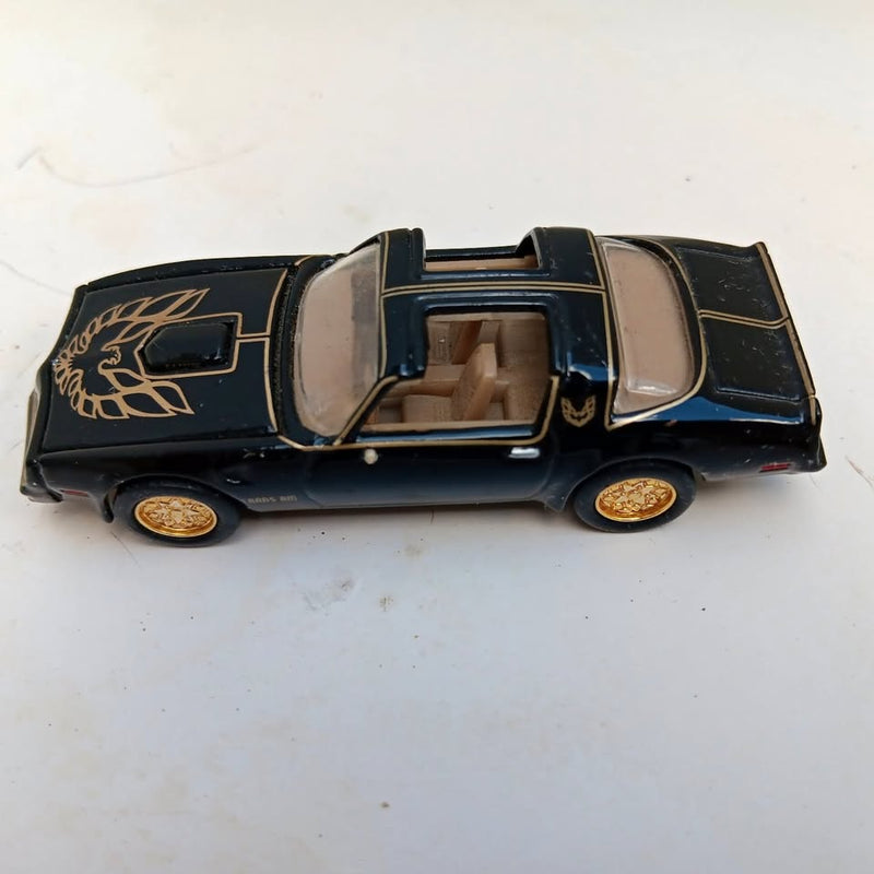 Diecast Pontiac Trans Am model car, dark blue with gold decals and open cockpit details
