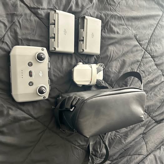 Drone remote controller set with gray carrying case and cream transmitter