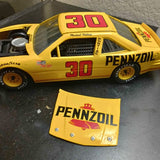 Yellow 1/24 diecast race car with red “30”, Pennzoil logo, and separate Pennzoil panel