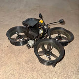 FPV quadcopter drone with four black propellers and small antenna