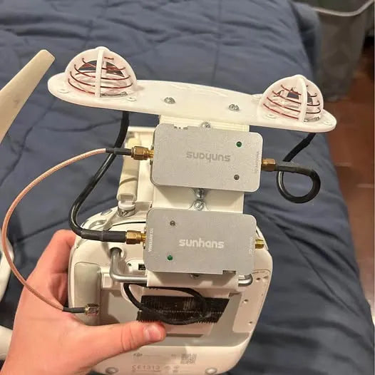 DJI Phantom drone with dual front sensor modules and camera gimbal, white body
