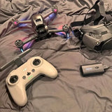 DJI FPV drone controller with antenna and drone frame, plus battery pack