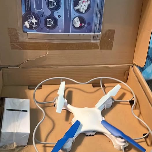 Kids quadcopter drone with white body and blue blades, four propellers