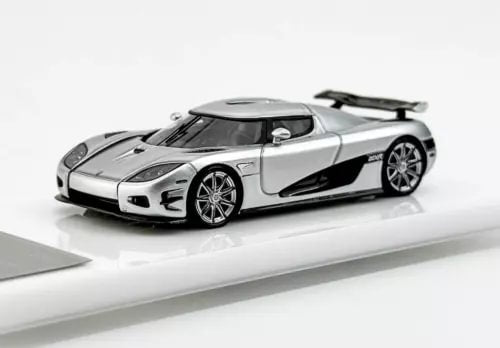 Silver racing sports diecast model car with black hood vents and large rear spoiler