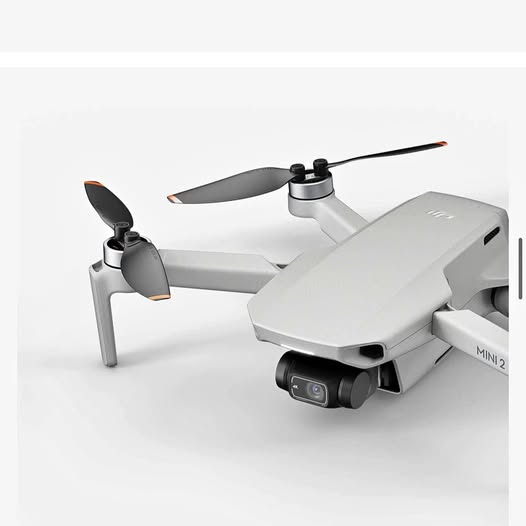 White quadcopter drone with foldable arms, propellers, and front camera