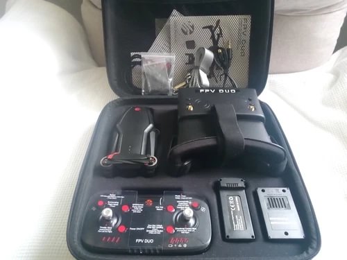 FPV drone camera set with flight goggles in hard case, controller and batteries visible