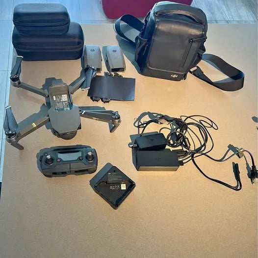 Foldable quadcopter drone with controller, batteries, cables, and carrying case
