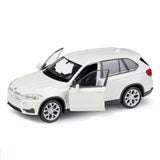 White diecast SUV model car with open driver door and detailed wheels