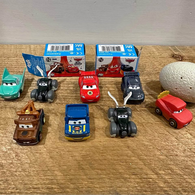Mini metal diecast racer cars lot, assorted cartoon-style vehicles in boxes