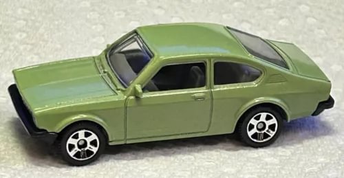 Mint green 1:64 diecast coupe car with black wheels and hood scoop, side view
