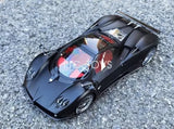 Black 1:18 scale diecast sports car model with open top and detailed wheels