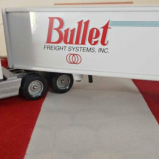 White diecast semi trailer with Bullet Freight Systems logo, mounted wheels detail