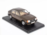 Die-cast model sedan car on display base, dark brown with cream interior.