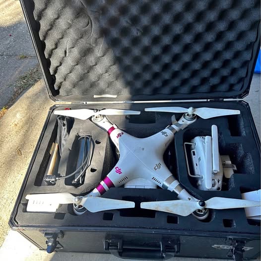 DJI Phantom 3 4G quadcopter in open hard case, white body and propellers