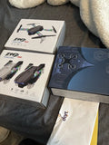 Foldable quadcopter drone in retail box, with prop guards and packaging
