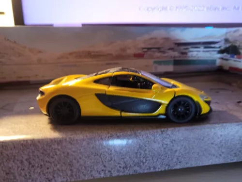 McLaren P1 diecast model toy car, yellow with blue side stripe, side view