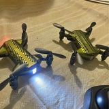 Drone set with controller: two green quadcopter drones with LED lights