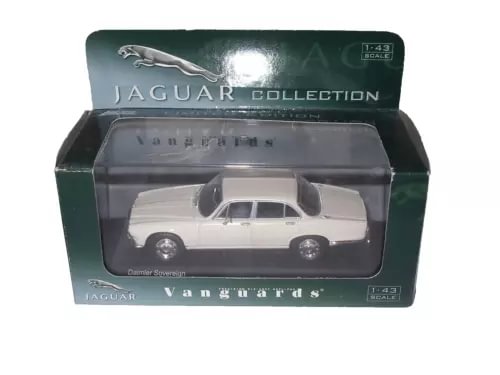 White diecast sedan model in clear display case with lid and box label