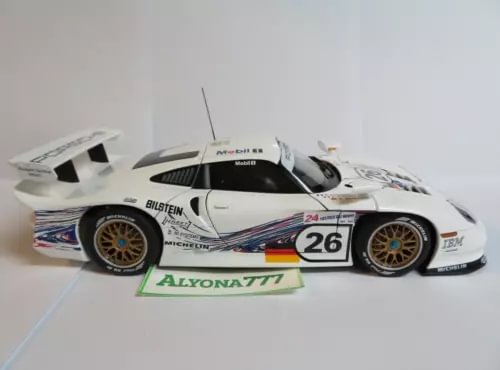 White diecast race car model with number 26 on doors, gold wheels