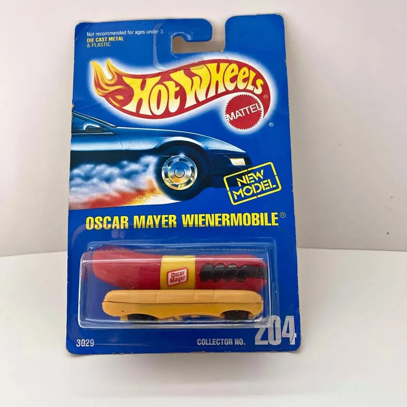 Hot Wheels Wienermobile diecast on blister card, red body, black wheels.